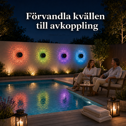 Ett par njuter av ett varmt spabad på kvällen. På väggen bakom badet lyser solcellslampor med stämningsfulla och färgstarka mandalamönster.