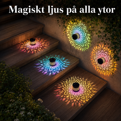 En trappa utomhus på kvällen där flera solarcellslampor har monterats och lyser upp stegen med vackra, färgglada mandalamönster.