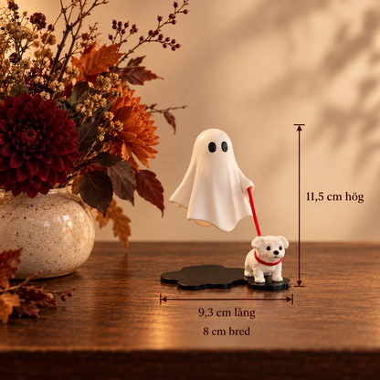 Spökvandringen dekorationsfigur bredvid en vas med höstblommor
